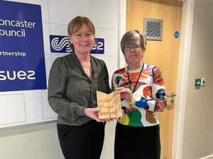 Tracey Brown, Account Manager at Systematic, receiving the award from Julie Swanepoel, Procurement Officer at SUEZ