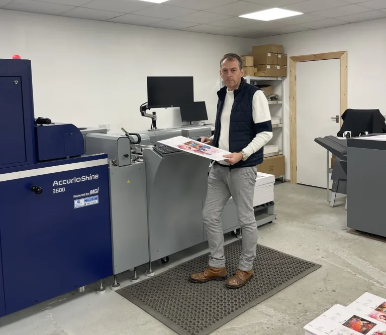 A key advantage of the Konica Minolta's digital high-end embellishment device is the cost savings versus conventional methods of thermographic varnishing and foiling.